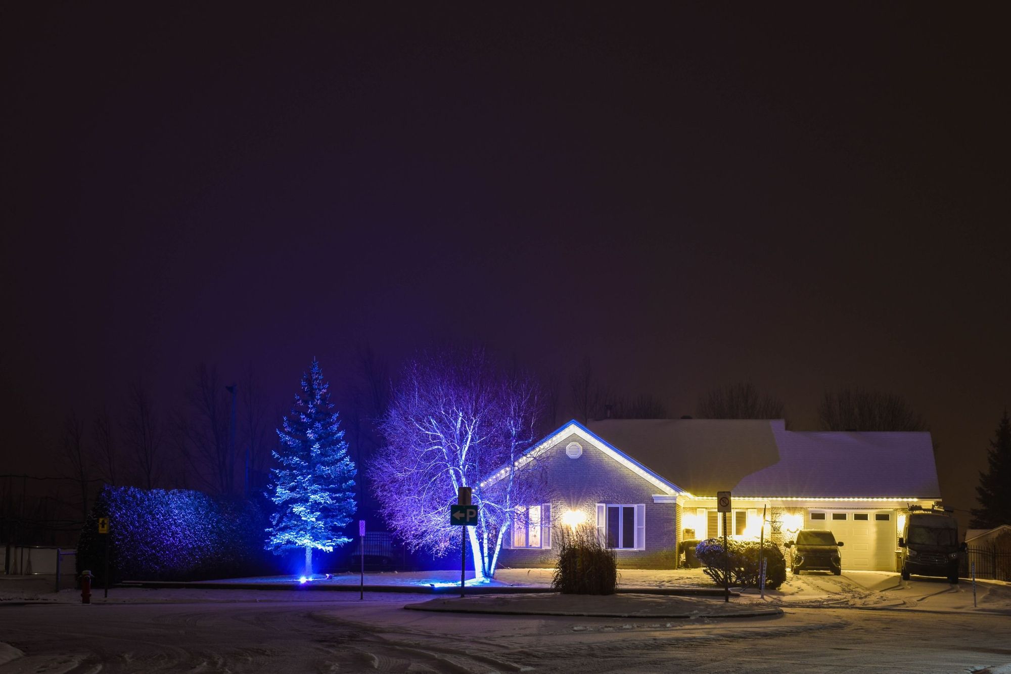 Single-story home at night with roofline lights